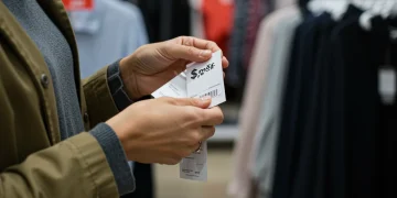Woman inspecting clothing tag for genuine apparel deal